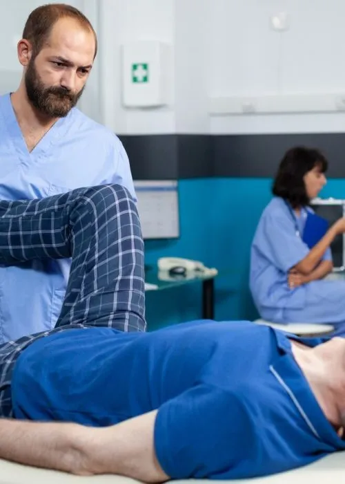 orthopedic-specialist-assisting-old-patient-with-leg-joint-injury